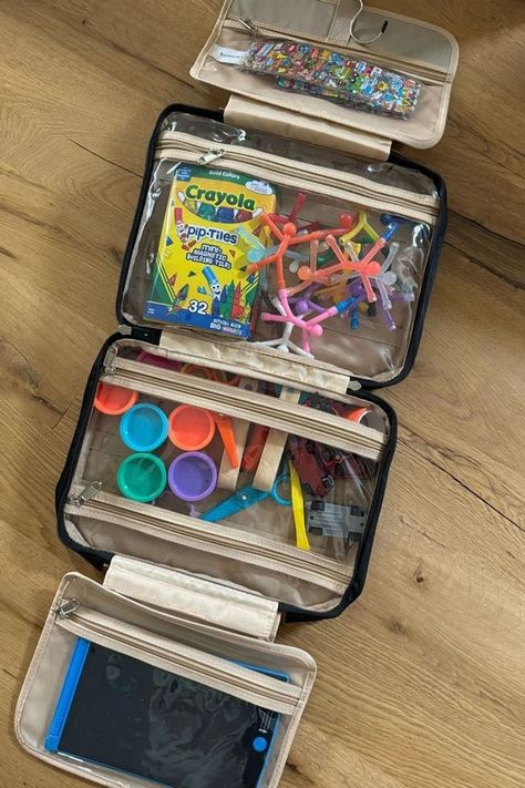 This hanging toiletry bag is a complete lifesaver on the travel days I have with my kids. My kids Busy bag is perfect for long or short trips. I've used it for airplanes, road trips and even at restaurants. I've ranked it in my top 5 essentials for traveling with kids. Tap to shop my favorite travel toys and gadgets for toddlers! Flying With Kids Hacks, Travel Box Ideas, Kids Road Trip Activities, Traveling Activities For Kids, Diy Travel Kits, Travel Hacks For Kids, Toddler Travel Bag, Road Trip Essentials For Kids, Kid Travel Kit