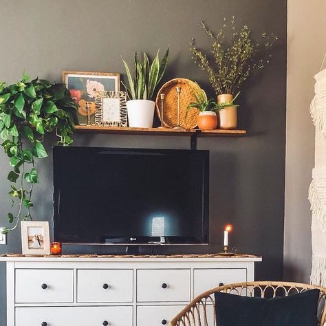 Sara Uribe 🌻 on Instagram: "Sometimes you just need to hide out in your room and eat your kids Halloween candy 🙈🤫 #bohostyle #bohohome #bohohomedecor #bohodecor #bohoinspired #boholivingroom #wickercabinet #rattanchair #plantstyle #plantsmakemehappy #bedroomdecor #tvshelf #shelfabovetv #mycurrentview #cozyhome #cozystyle #homedecor #myhomestyle #plantstyle #myhomevibe #gofinding #homegoods #collectedhome #dad110420ls #iny110420l" Shelf Over Tv Bedroom, Over The Tv Shelf Decor, Shelf Above Tv Bedroom, Above Tv Shelf Decor, Shelving Above Tv, Shelf Above Tv Decor, Above Tv Shelf, Shelf Above Tv Living Room, Shelf Over Couch