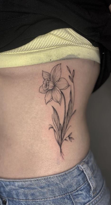 Tatoos Small Daffodil, Vintage Daffodil Tattoo, Fine Line Flower Tattoo Daffodil, Daffodil Tattoo Realistic, Daffodil Behind Ear Tattoo, Daphodil And Daisy Tattoo, Daffodil Tattoo Forearm, Pink Daffodil Tattoo, Daffodil Tattoo Bouquet