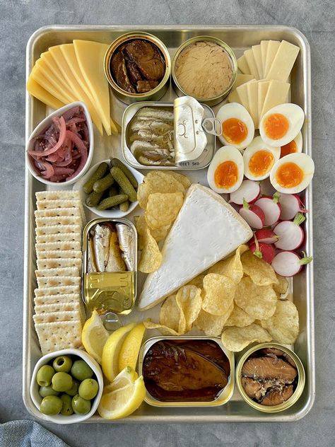 Tinned Fish Board Tin Fish Charcuterie, Smoked Fish Charcuterie Board, Sardine Charcuterie Board, Tinned Fish Charcuterie Board, Tin Fish Board, Yacht Party Food, Tinned Fish Aesthetic, Tinned Fish Board, Tinned Fish Recipes