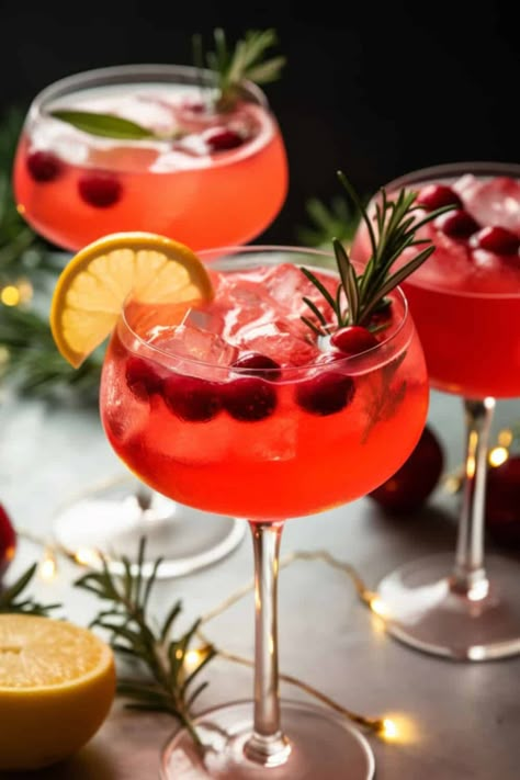 sparkling glass of Santa's Spritz Christmas Cocktails, with rich red cranberry juice, bubbly prosecco, and a hint of ginger gin, garnished with a sprig of rosemary. Drinks Alcohol Recipes Winter, Christmas Cocktail Party Ideas, Cocktails With Champagne, Christmas Cocktails For A Crowd, Hot Christmas Drinks, Loaded Mashed Potato Balls, Sparkling Wine Drinks, Bunco Christmas, Easy Winter Cocktails