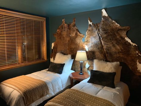 Brindle cow hides hung on wall in bunk room Cow Hide Rug Hanging On Wall, Cow Hide Bedding, Cowhide Hung On Wall, Cowhide On Wall, Cow Hide Headboard Beds, Cowhide On Wall Ideas, Deer Hide On Wall, Room Western, Chalet Ideas