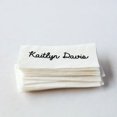 Sew-in custom clothing name labels, printed on white organic cotton and pre-cut. 1.  Select font (from last photo) and size/quantity at checkout (default is 20  2" x 1" labels, but there are many additional options).  You can choose "custom" for the font and leave the name of a different font in "notes to seller" if you prefer.   2.  Leave name you want printed in the personalization box. 3.  Get labels! These personalized name tags are printed in black ink on 100% organically grown cotton.  The Labels For Clothing, Sewing Logo, Clothing Labels Design, Custom Clothing Labels, Kids Clothes Sale, Label Ideas, Sewing Labels, Cheap Kids Clothes, Labels Design