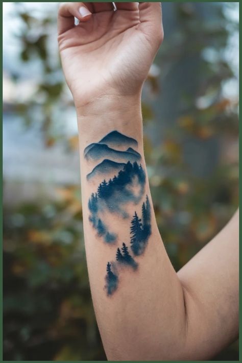 Forearm tattoo of misty mountains and pine trees in shades of blue. Wrist Tattoo Designs For Women, Unique Wrist Tattoos, Wrist Tattoo Designs, Wrist Tattoo Ideas, Mountain Silhouette, Twilight Sky, Tattoo Ideas For Women, Wrist Tattoos For Women, Tattoo Bracelet