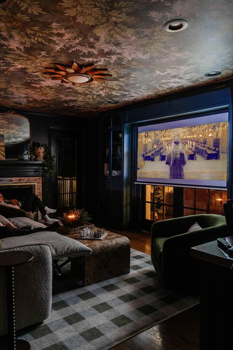 How to design the perfect small home theater setup with flexible media room seating, storage, lighting, and decor for a cozy space to spend family time. Library And Media Room, Maximalist Media Room, Movie Room On A Budget, Family Theater Room, Eclectic Movie Room, Moody Basement Theater, Media Room Aesthetic, Playroom Theatre Room Combo, Cosy Media Room