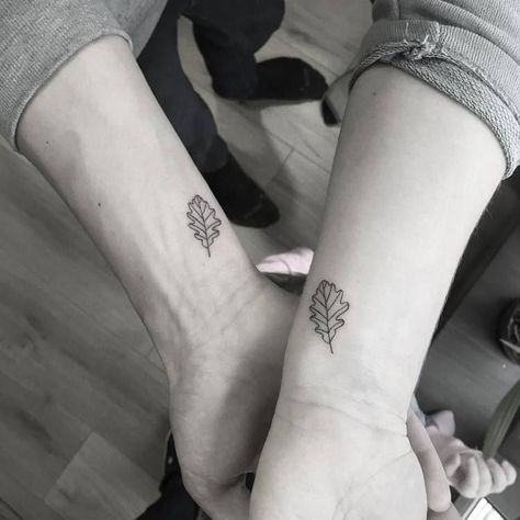 Matching oak leaves tattoos on inner wrists – tattoo idea for a couple Oak And Maple Leaf Tattoo, One Leaf Tattoo, Acorn Oak Leaf Tattoo, Oak Leaf Tattoo For Women, Acorn Leaf Tattoo, Matching Leaf Tattoos, Elm Leaf Tattoo, Tattoo Oak Leaf, Sycamore Leaf Tattoo