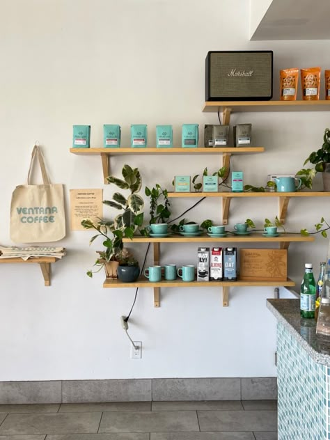 Coffee Shop Product Display, Coffee Shop Merch Display, Cafe Gallery Wall, Cafe Merchandise Display, Bakery Merchandise Ideas, Coffee And Plant Shop, Product Display Wall, Cafe Shelf, Coffee Plant Tattoo