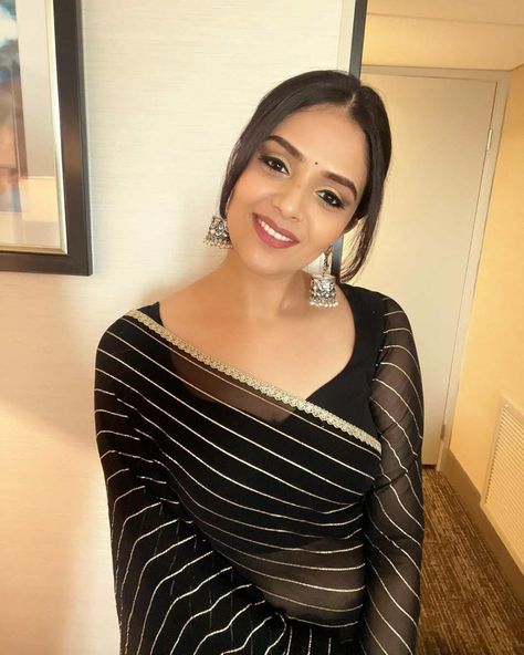 sreemukhi in a black saree by cinderellas closet Black Chiffon Saree, Striped Saree, Oxidized Silver Earrings, Full Sleeve Blouse, New Saree Blouse Designs, Blush On Cheeks, Black Saree, Black Chiffon, Saree Look