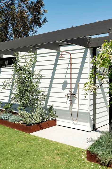 An outdoor shower is surrounded by contrasting shapes and hues with the olive tree, Elijah blue grass and African satin bush. Outdoor Shower Poolside, Outdoor Shower For Pool, Manifesting House, Outdoor Shower With Clear Roof, Outdoor Shower Lake House, Outdoor Shower Enclosure Beach Houses, Pool Planters, Street Scape, Outdoor Shower Ideas