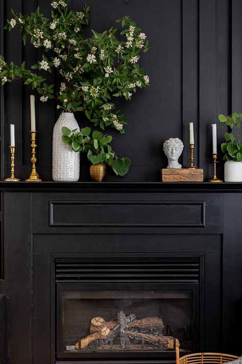 Dark Mantle Decor, Moody Fireplace Mantle Decor, Black Fireplace Styling, Painted Antique Fireplace Mantel, How Wide Should A Fireplace Mantle Be, Black Mantle Decorating Ideas, Dark Mantle Decorating Ideas, Black Fireplace Decor Ideas, Moody Mantle Decor