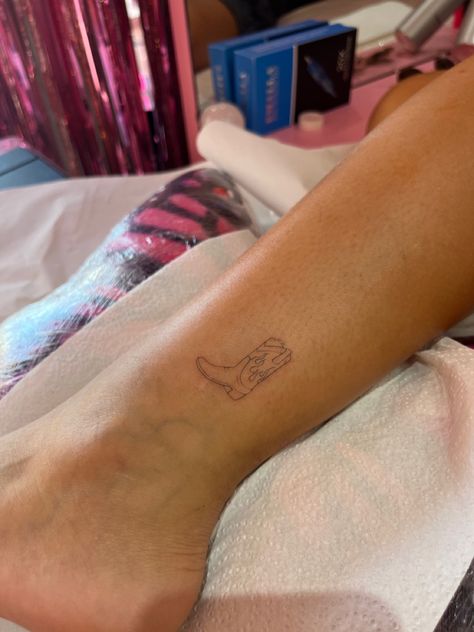 Cowboy Boot Tattoo On Ankle, Nashville Tiny Tattoos, Dainty Cowboy Boot Tattoo, Cowboy Stick And Poke, Country Style Tattoo For Women, Fine Line Cowboy Boot Tattoo, Tiny Cowboy Boot Tattoo, Yeehaw Tattoo, Cowboy Boots Tattoo