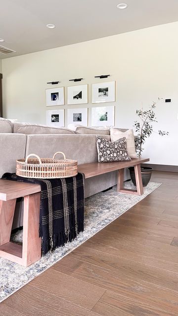 Elisabeth Yeary | organic modern | on Instagram: "Reasons I love a bench over the traditional console table behind the couch: ▫️provides additional seating ▫️it’s perfect for open concept homes ▫️the low profile makes your space feel more open. ▫️gives your guests somewhere to leave their bag . . . . . #naturaldecor #ltkhome #ltkstyletip #neutraldecor #behindthesofa #homestyling #openconcept #benchstyling" Bench Seating Family Room, Console Table Bench, Couch Placement Ideas Open Concept, Wooden Bench Behind Sofa, Wood Bench Behind Sofa, Back Of Couch Bench, Behind The Couch Bench Decor, Behind Sofa Bench, Kitchen Table Behind Couch