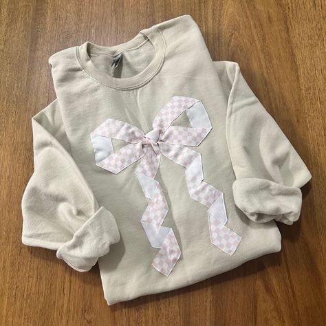 This cute design makes the perfect gift for the bow lover in you life. The beautiful checkered ribbon is sewn on. Go up in size for a more oversized look. All sales are final due to customization of product. Will ship USPS or UPS unless requested otherwise. Colors and exact shape of bow may differ slightly from appearance on screen. Patch Work Sweatshirt, Ribbon Sweater, Thrift Flip Ideas, Bow Sweatshirt, Stitch Sweatshirt, Patch Sweatshirt, Trendy Bows, Patchwork Sweatshirt, Quilted Sweatshirt