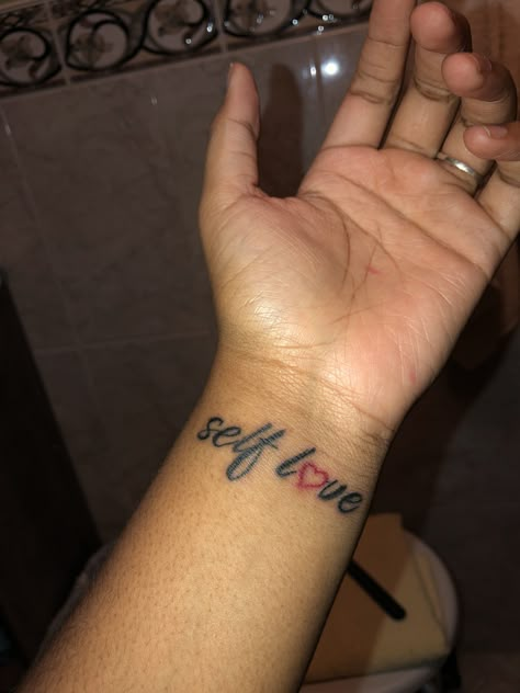 Self Love Wrist Tattoo Self Love Hand Tattoo, Love Yourself Tattoos For Black Women, Little Wrist Tattoos For Women, Baddie Wrist Tattoos, Red Ink Wrist Tattoo, Self Love Wrist Tattoo, Tattoo Ideas Black Women Self Love, Wrist Tattoo Black Women, Wrist Tattoos For Black Women