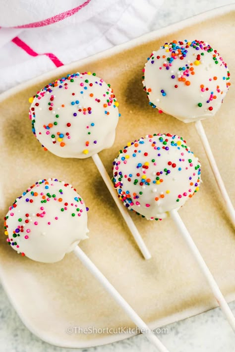 For a fun party activity, try making this easy cake pop recipe with the kids. It's simple to make with cake mix and a jar of frosting, but homemade ingredients from scratch can be used too! When it comes to decorations, the kids will have a great time coming up with their own sweet creations. #easycakepoprecipe #cakepopsrecipe #easybirthdaycakepops #theshortcutkitchen Funfetti Cake Pop, Cake Pops From Box Cake, Cake Pop Recipe With Box Cake, Easy Cake Pops 3 Ingredients, How To Make Cake Pops Easy, Cake Pop Easy, Cake Pops Recipe Easy, Cake Pops Recipe From Scratch, Valentine Baking Recipes