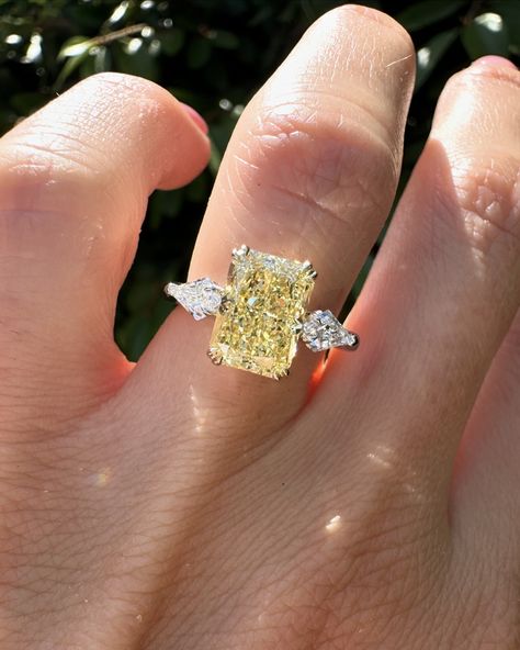 Swipe for more angles of this stunning yellow Radiant cut. 2.57ct yellow radiant cut diamond with kite side stones set in 14k yellow gold & platinum. #radiantcut #radiantcutdiamond #radiantcutdiamond #engagementring #diamondring #proposal #showmeyourrings #gettingmarried #howtheyasked #bridetobe #theknotrings #imengaged #theysaidyes #isaidyes #engaged #customjewelry #finejewelry Yellow Stone Engagement Rings, Yellow Canary Diamond Ring, Light Yellow Diamond Engagement Ring, Wedding Ring Yellow Diamond, Yellow Topaz Engagement Ring, Kite Side Stones, Canary Engagement Ring, Engagement Ring Yellow Diamond, Canary Diamond Engagement Ring