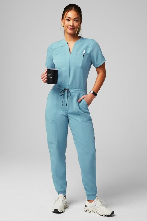 Empower Scrub Jumpsuit - Yitty Dentist Scrubs Woman, Professional Scrub Outfit, Peds Nurse Outfit, Nurse Style Scrubs Fashion, Scrubs Jumpsuit, Scrubs Uniform Aesthetic, Doctor Outfit Ideas, Scrubs Uniform Cute Fashion Styles, Stylish Scrubs For Women