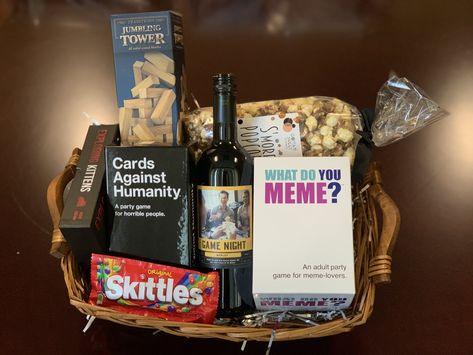 Great gift idea! Recreate this gift basket by visiting our website to find the store nearest you that carries #GameNightWine #merlot #themenightwines #cardsagainsthumanity #whatdoyoumeme #jenga #giftbasketideas #giftideas #housewarminggifts #giftideas #giftsforteachers #teachergiftideas #winebaskets #winegifts Jack And Jill Gift Basket Ideas, Super Bowl Gift Basket Ideas, Prize Baskets For Adults, Prize Basket Ideas For Adults, Inexpensive Gift Basket Ideas, Game Night Basket Ideas, Themed Baskets For Raffles, Game Gift Basket, Game Night Gift Basket Ideas