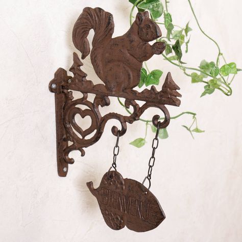 Decorative iron wall plaque perfect for adding vintage country style to the entrance. Making a lovely gift idea.Made from cast iron finished in an rustic antique brown this lovely country squirrel welcome sign is a great addition to the entrance of your home. Featuring a decorative hanging acorn welcome sign with the wording "Bienvenue" this French country style wall bracket makes a great garden or doorstop accessory.Cast ironH30 x L19cm Cast Iron Hanging, Squirrel Nutkin, Squirrel Decor, Squirrel Gift, Fall Front Door, Entrance Sign, Fall Porch, Rustic Signs, French Country Style