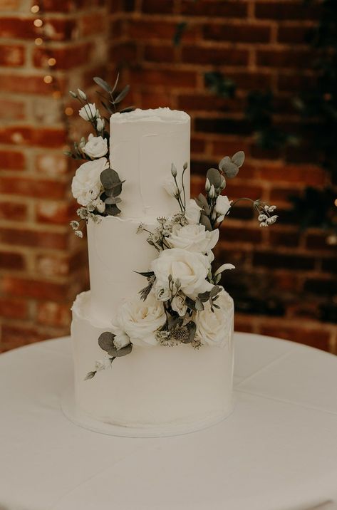 Wedding Cake White And Green Flowers, Wedding Cake Ideas Elegant Sage Green, Wedding Cake Designs Eucalyptus, Minimal Floral Wedding Cake, White Greenery Wedding Cake, Wedding Cakes Greenery, White And Greenery Wedding Cake, Simple 3 Tier Wedding Cake With Flowers, Wedding Cakes Green And White