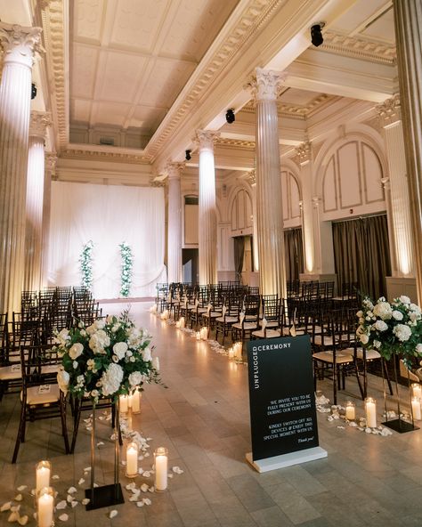 A wedding ready to welcome guests from every angle 🖤 Alana & Ryan | 10.28.2023 Florals | @tularosefloralevents Venue | @treasuryontheplaza Planning | @coastalcelebrationsstaug Photography | @angelita_photo Signage | @andimejiaco Rentals | @stjohnsilluminations ✿ #weddingflorist #floridaweddingflorist #staugustinewedding #staugustingweddings #staugweddings #thetreasuryontheplaza #thetreasury #treasurywedding #weddingflowers #moodyweddinginspo #floraldesigner #weddingarrangement #flor... Elegant Indoor Wedding Ceremony, Ceremony Flowers Indoor, The Plaza Wedding, Ceremony Decorations Indoor, Treasury On The Plaza, Aisle Florals, Floral Arbor, Wedding Ceremony Decorations Indoor, Wedding Ceremony Design