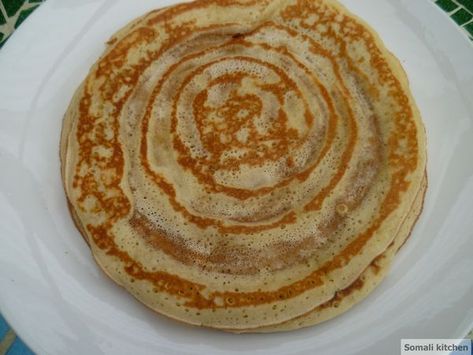 Malawah is a plate sized sweet pancake that is perfect for breakfast or as snack anytime during the day. While there are slight variations in how Somalis make this pancake, this particular recipe with its fragrant touch of cardamom is how I like my malawah. I love eating malawah with... Malawah Somali, Somali Recipes, Somali Recipe, East African Food, Somali Food, Chapati Recipes, Kenyan Food, Sweet Pancakes, Cultural Food