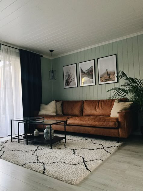 Picture Of a modern living room with sage green slatted walls, a brown leather sofa, black metal and glass tables and a gallery wall Sage Living Room, Green Walls Living Room, Sage Green Living Room, Green Living Room Decor, Sage Green Bedroom, Green Living Room, Room Green, Living Room Color Schemes, Green Home Decor