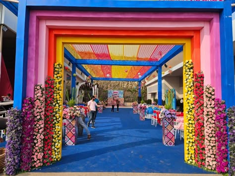 Grand Haldi & Mehendi carnival Rainbow Entrance Decoration, Carnival Gate Entrance, Haldi Entry Gate Decor, Carnival Entrance Decor, Carnival Mehendi Decor, Carnival Entrance Ideas, Colorful Haldi Decor, Carnival Decorations Ideas Entrance, Wedding Carnival Theme Decor