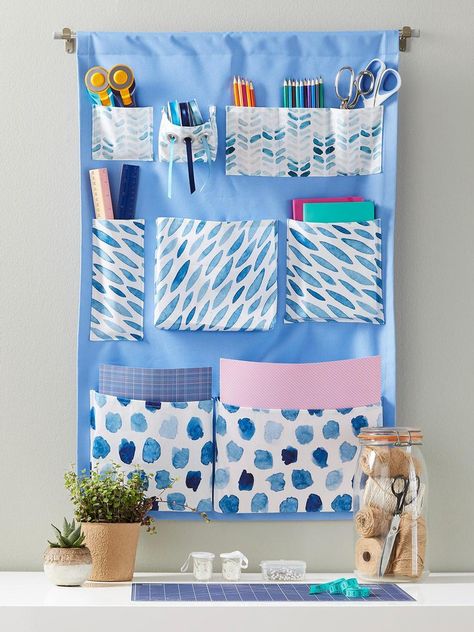 You Can Outfit This Hanging Organizer With Pockets Big and Small to Keep All Your Craft Items in Their Place Sew Wall Organizer, Diy Hanging Storage Pockets, Sew Hanging Wall Organizer, Hanging Organizer Sewing Pattern, Diy Fabric Bunting, Diy Pocket Organizer Wall Hangings, Hanging Pocket Organizer, Fabric Wine Bags, Hanging Wall Organizer