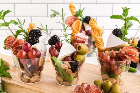 With these Charcuterie Cups, guests can carry the whole snack assortment wherever they go. Perfect for any gathering and easy to customize. Champagne Cup Charcuterie, Individual Charcuterie Board, Aesthetic Charcuterie, Graze Boards, Fancy Snacks, Charcuterie Board Display, Individual Charcuterie, Clear Aesthetic, Holiday Catering