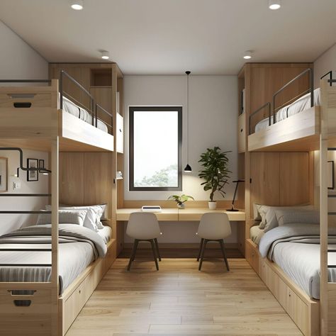 This Scandinavian dormitory room combines functionality and minimalism. It features two sets of wooden bunk beds with built-in storage drawers, maximizing space. A central study area with a long desk and two modern chairs is perfect for academic activities. Natural light floods the room through a large window, highlighting clean lines and simple decor like a potted plant and minimalist lighting, creating a bright and inviting atmosphere. Minimal Bunk Beds, Scandinavian Bedroom Bunk Bed, Hostel Room Interior, Dormitory Room Design, Modern Orphanage, Modern Student Housing, Student Hostel Room Design, Room For 4 People, School Dormitory Room