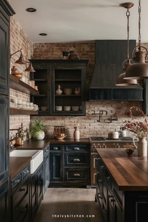 Rustic kitchen with dark cabinets, wooden countertops, exposed brick walls, and copper utensils. Black Room Wood Accents, Black Cabinets Brick Backsplash, Butcher Block Countertops Dark Cabinets, Dark Cottage Core Kitchen, Rustic Black Kitchen Cabinets, Moody Cottage Kitchen, Blank Wall In Kitchen Ideas, Brown And Black Kitchen, All Black Kitchen Ideas