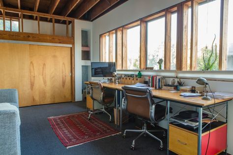 Vintage Soft Pad chairs by Charles and Ray Eames for Herman Miller (an eBay find) and matching new Eames desk and storage units, also from Herman Miller, furnish a workspace on the mezzanine level. "When we're both at home we speak to each other all the time," William says of the openness of the house. Eames Desk, Eames Storage Unit, Eames Office Chair, Desk And Storage, Desk Units, Adirondack Chair Plans Free, Tiny Desks, Eames Office, Arm Chair Styles