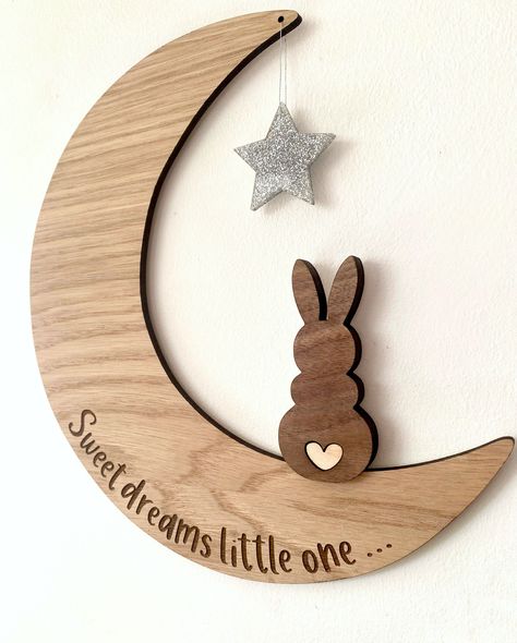 If you are looking for a unique and special piece of decor for your baby's nursery, then look no further. This moon, with it's cute wooden bunny is a beautiful addition to any baby's room, as it's neutral wooden tones and engraved message fit perfectly with any nursery decor. The moon is made from an oak veneered wood and the bunny sits on top in a darker walnut. It has a cute little heart tail, which is cut from lighter wood and inserted into the walnut for a high quality finish. The star which Wooden Decor Pieces, Nursery Wood Decor, Wooden Moon Wall Decor, Baby Laser Cut Ideas, Wooden Nursery Decor, Wood Laser Engraving Ideas, Wood Nursery Decor, Laser Cut Wall Art, Laser Crafts