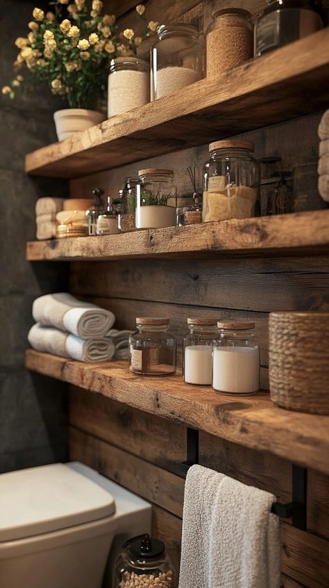 Rustic bathroom with wooden shelves displaying jars and towels, blending warmth and organic beauty in a cozy setting. Natural Wooden Shelves, Wood Shelves Over Toilet, Men’s Bathroom Storage, Diy Rustic Shelf Ideas, Rustic Bathroom Shelving, Real Wood Shelves, Large Bathroom Shelves, Rustic Bathroom Shelf Decor, Bathroom Organization Over Toilet