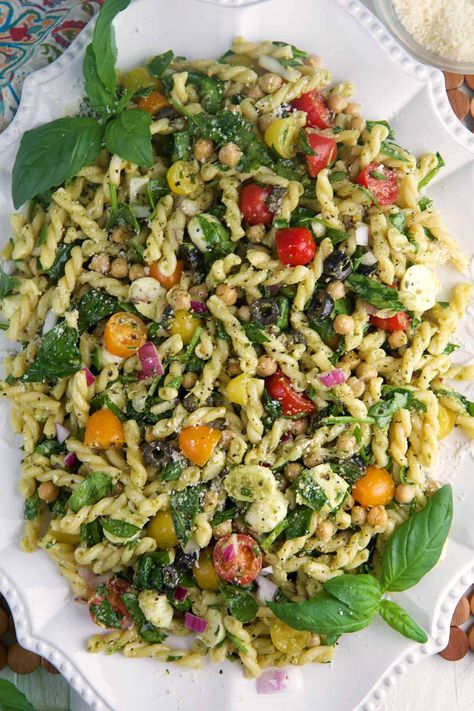 Easy Pesto Pasta Salad is the perfect dish for picnics, or a light lunch. This vibrant salad combines pasta, juicy tomatoes and basil pesto. Easy Veggie Pasta Salad, Easy Pesto Meals, Basil Side Dish Recipes, Pesto Pasta Salad With Peas, Pasta Salad Summer Cold, Pasta Salad Veggie, Zesty Chicken Enchilada Pasta Salad, Spinach Pesto Pasta Salad, Basil Pasta Salad Recipes