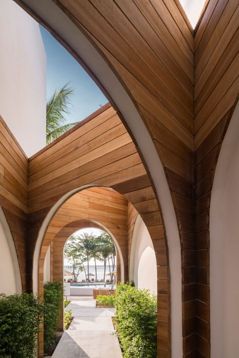 Connecting the various parts of this modern hotel are wood lined walkways that contrast the white exterior of the hotel. #Walkway #Wood #Arches Hotel Design Architecture, Chaweng, Ko Samui, Resort Architecture, Resort Design, Salalah, Beach House Interior, Modern Hotel, Architecture Inspiration