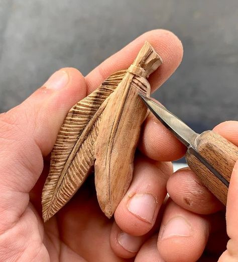 Patryk Roszak on Instagram: "Two feathers pendant, hand carved in plum wood 🪵 Work in progress!🪶🪶 - - - - - #wood #woodcarving #woodart #handmade #handmadewithlove #handmadejewelry #fineart #jewelryofinstagram #jewelrygram #jewelry #pendant #necklace #woodpendant #wooden #woodnecklace #woodjewelry #feather #giftideas #plumwood #feathers #handcarved #slowcraft #knifecarving #workinprogress #jewelryart #jewelryartist #nativeamerican #nativestyle #🪶" Wood Whittling Ideas, Whittling Pendants, Wood Carving Necklace, Wood Carved Pendants, Feather Wood Carving, Wood Carved Necklace, Carved Wooden Pendant, Ornamental Wood Carving, Nature-inspired Carved Pendant Jewelry