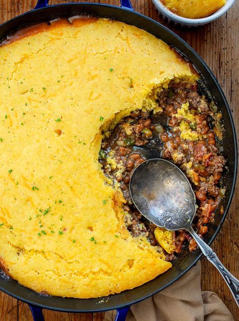 Cornbread Cowboy Casserole is made with a cowboy baked bean and ground beef base, and a delicious cheesy cornbread topping. Cowboy Casserole, Casserole Recipes, Cornbread Casserole, Cornbread Meat Casserole, Dinner, Supper, Campfire Recipes, Camping Recipes, Dinner Recipes, Hearty Dinner Recipe, i am homesteader, iamhomesteader Cast Iron Cowboy Casserole, Recipes To Go With Cornbread, Cornbread Skillet Casserole, Homemade Cornbread Casserole, Cowboy Skillet Casserole, What To Eat Cornbread With, Cowboy Dinner Ideas, Hamburger And Cornbread Recipes, Main Dishes For Dinner Beef