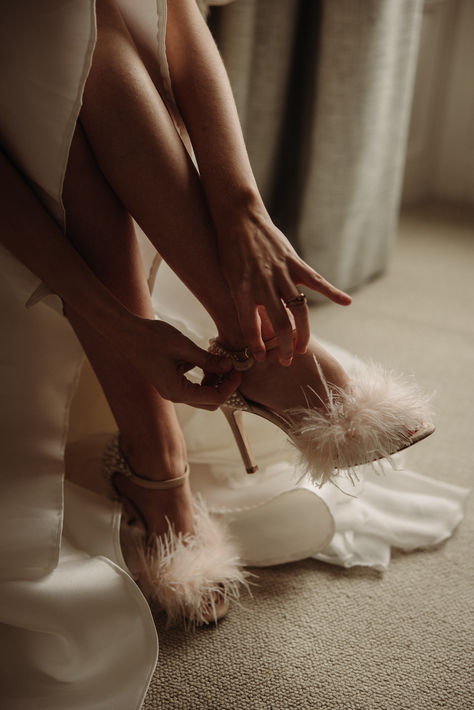 Bride putting on her white stiletto heels feather wedding shoes | bridal shoes | bridal accessories | wedding styling | feather wedding accessories | Katie Goff Photography White Feather Heels, Feather Wedding Shoes, Bride Shoes Low Heel, Comfortable Bride Shoes, Comfortable Wedding Shoes Flats, Bride Shoes Flats, White Stiletto Heels, Jimmy Choo Wedding Shoes, Bride Heels