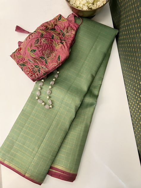 Our signature color combination, cardamom green and pink, finally debuts in the Charita style. Sink your eyes into this pure handloom kanchipuram silk saree with pure zari checked body with pink accents and witness how simplicity and opulence seamlessly merge in this exquisite drape. The pink and zari selvedge and zari striped pink pallu are the perfect accents to the cardomom green body. Pick one of very many of our blouses to pair beautifully with it or use the pink blouse that comes with the saree, either way, you are gaunrateed a stunning look. Different Colour Combinations In Sarees, Green Saree Pink Blouse Designs, Pink Contrast Color Combinations Dresses, Saree And Blouse Color Combinations, Green Contrast Color Combinations, Sarees Combination, Saree Color Combinations, Pink Blouse Designs, Stylish Kurtis Design