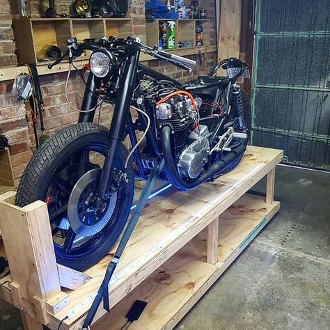 Home workshop goal achieved. Built this plywood bike stand for under $100 thanks to @krankengineering. We added LED strips to shed some extra light on things. You can find the plans for this stand free on his website krankengineering.com ... #krankengineering #motorcycle #diy Motorcycle Table, Motorcycle Storage Shed, Motorcycle Lift Table, 10x12 Shed Plans, Motorcycle Build, Motorcycle Lift, Motorcycle Stand, Motorcycle Wiring, Motorcycle Storage