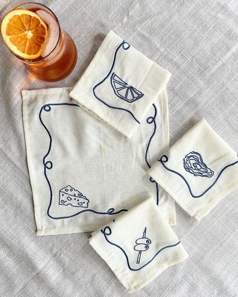 Happy long weekend!🧡 We hope you are celebrating with an Aperol Spritz (or a glass of wine from @chinchincreemore !) and some appetizers paired with our embroidered napkin sets✨ The perfect gift for nights at a friend’s house. Did you know Laurie drew the illustrations, Tessa digitalized them and we had them embroidered? Each set (Apero, Veggies, Hi!, and Bathers) come with 4 unique illustrations #tablescape #hostessgift #summerdinner #summerevenings #summerparty #cockatil #cocktailparty #ap... Cloth Napkins Embroidery, Embroidery Designs For Napkins, Table Napkin Embroidery Ideas, Napkins Embroidery Design, Diy Embroidered Napkins, Embroidered Napkins Ideas, Italian Embroidery Design, Embroidered Dinner Napkins, Embroidered Napkins Diy