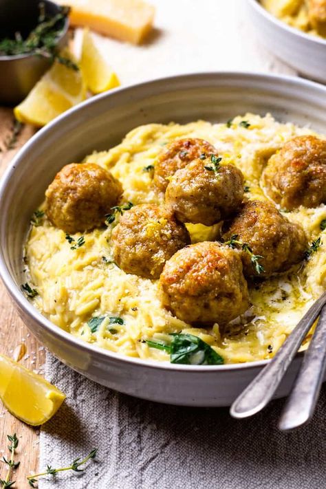 Easy to make, bursting with fresh lemon flavor and so delicious! Tender chicken meatballs are baked in lemon and garlic infused butter and served over creamy parmesan spinach orzo that's all made in just one pot! Serve the meatballs over the creamy orzo and drizzle with extra lemon butter. Creamy Spinach Orzo, Butter Chicken Meatballs, Chicken Meatball Recipe, Spinach Orzo, Chicken Meatball, Chicken Meatball Recipes, Lemon Butter Chicken, Creamy Spinach, Chicken Meatballs