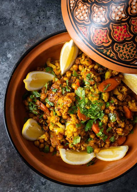 This recipe for vegetable tagine makes a hearty Moroccan dish with carrots, cauliflower, and chickpeas in a flavorful, aromatic stew. Vegan Berbere Recipes, Tajine Recipes Vegetarian, Moroccan Tagine Recipes Vegetarian, Vegetarian Tagine Recipes, Vegan Tagine Recipes, Moroccan Vegetarian Recipes, Tagine Recipes Vegetarian, Moroccan Appetizers, Moroccan Party Food