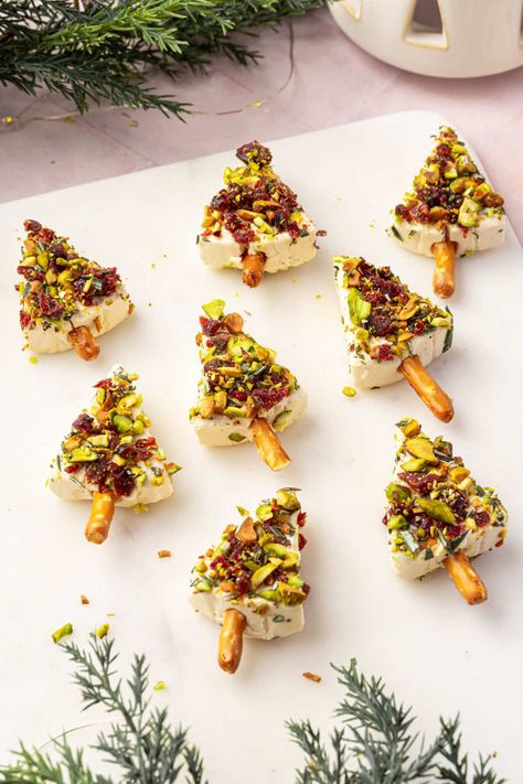 Turn your holiday appetizers into a festive centerpiece with these adorable cheese Christmas trees! Creamy Laughing Cow cheese wedges are transformed into mini Christmas trees, coated in a flavorful mix of pistachios, dried cranberries, and Christmas Cheese Tree Appetizer, Christmas Trees Appetizer, Cheese Trees Snack, Puff Christmas Tree, Dill Pickle Christmas Tree, Festive Italian Cheese Log, Laughing Cow Cheese Christmas Trees, Laughing Cow Appetizers, Christmas Tree Cheese Appetizer