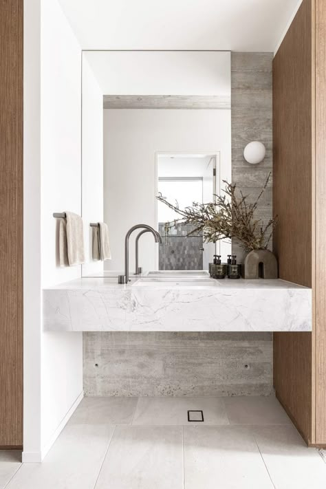 The Grotto: Brutalist Architecture Meets Biophilic Design in This Modern Masterpiece | (NZ) ABI Bathrooms & Interiors Gunmetal Tapware, Limestone Bathroom, Dolomite Stone, Build Office, Abi Interiors, Natural Stone Bathroom, Stone Vanity, Stone Mirror, The Grotto