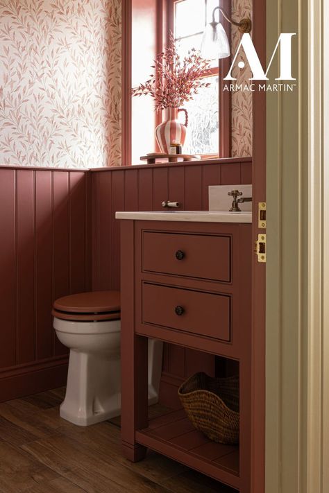 This colourful en suite bathroom is flooded with colour. An earthy pink tone drenches the wall panelling and blends in to the vanity unit whilst the floral wallpaper softens the space. Vanity unit by Holly Oak House. Renovation by Rachael Somerville. Colorful Small Bathroom, Small Ensuite Ideas, Small Ensuite Bathroom, Ensuite Bathroom Designs, Kitchen And Utility, Small Ensuite, Small Bathroom Wallpaper, Earthy Pink, Cloak Room