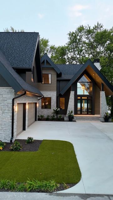 Hamed Homes on Instagram: "All the feels… ⁣ ⁣ Design Architect:⁣ @david.charlezdesigns  Interior Design:⁣ @carbon6interiors  Landscape Architect:⁣ @earthlandarch  Windows:⁣ @andersen_windows  Exterior Siding:⁣ @deltamillworks  ⁣ ⁣ ⁣ ⁣ ⁣ ⁣ #custombuild #newhomes #customhome #homebuilder #build #indiana #custombuilt #customhomes #newhomeconstruction #buildersofig #buildersofinsta #itsahamedhome" Modern Arts And Crafts Exterior, Modern Dark House Exterior, Modern Ranch Home Exterior, Gray Stucco House Exterior, Dark Stone Exterior Houses, Modern Farmhouse House Exterior, L Shape House Design Exterior, Modern Rustic Exterior House, Modern Shutters Exterior