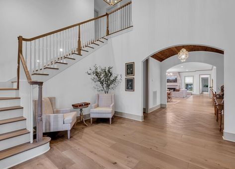 Barrel ceilings and beautiful staircase-this foyer is a showstopper! What’s your favorite detail? 👀💕 Tall Foyer, Stairway Entry, Curved Stairway, White Foyer, Barrel Ceiling, Barrel, New Homes, Ceiling, Quick Saves